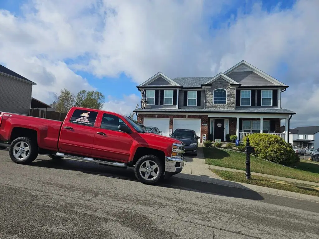 Big Red Contracting branded truck at a completed roof and siding project in Frankfort, Kentucky